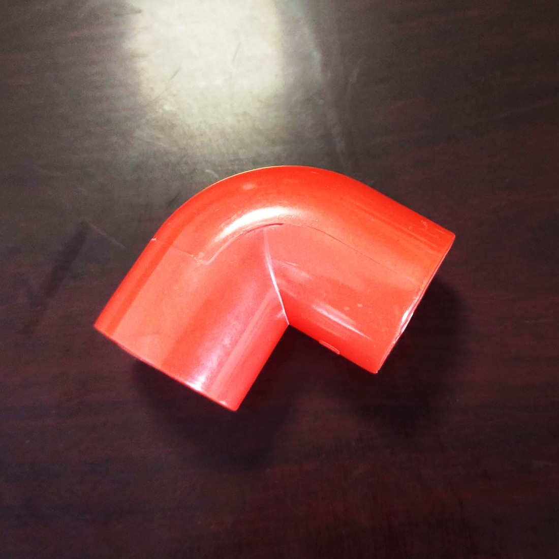 Red PVC conduit elbow, conduit joint, conduit elbow, electrician conduit bend