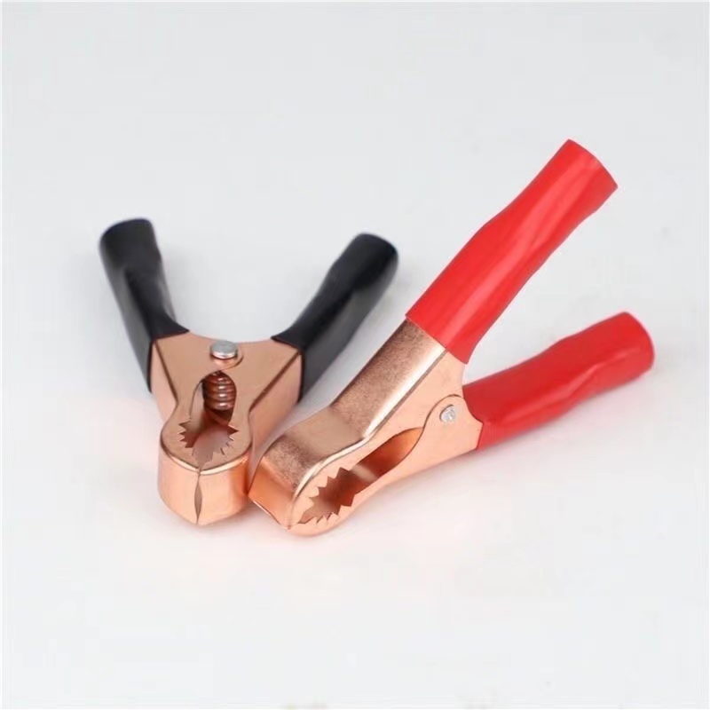 Car battery clip made of thickened pure copper and used for connecting wires. Crocodile clip for connecting batteries. Small size